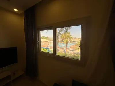 a window in a room with a view of a pool at شاليه بمنتجع ميراج Mirage apartments in Hurghada