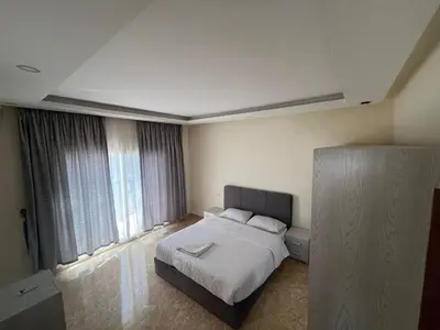 a bedroom with a bed and a large window at شاليه بمنتجع ميراج Mirage apartments in Hurghada