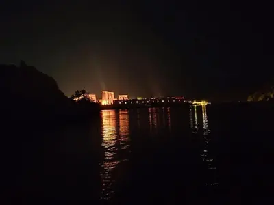 a bridge over a body of water at night at Nubian Spirit in Aswân Reservoir Colony