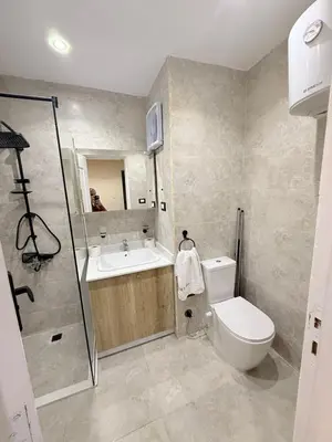 a bathroom with a toilet and a sink and a shower at Nubia Beach Resort in Hurghada