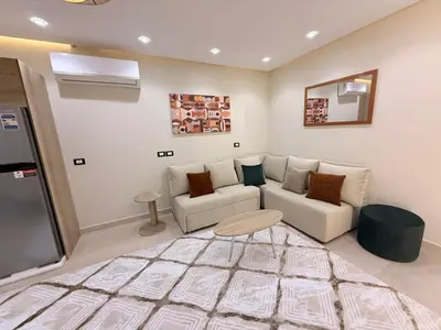 a living room with a couch and a table at Nubia Beach Resort in Hurghada