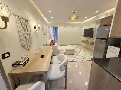 a kitchen and living room with a table and chairs at Nubia Beach Resort in Hurghada