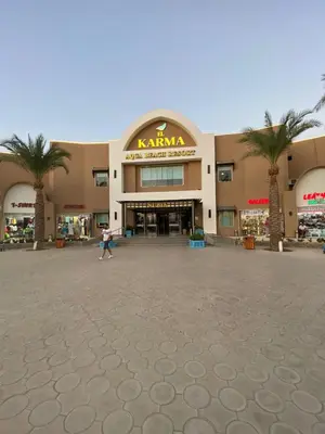 a person walking in front of a shopping center at Nubia Beach Resort in Hurghada
