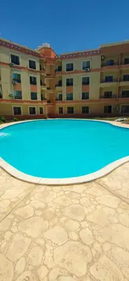 an empty swimming pool in front of a building at Red Ruby chalets & flats HRG Elgouna in Hurghada