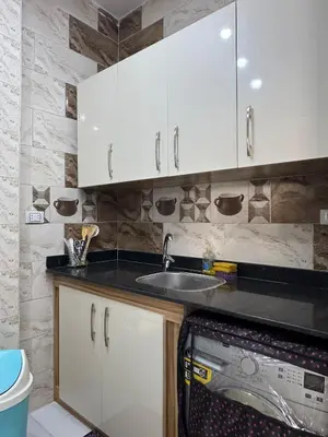 a kitchen with a sink and a washing machine at Inter Prime apartment 4 in Hurghada