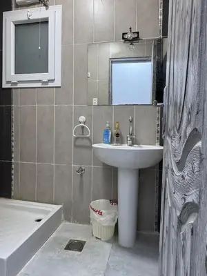 a bathroom with a sink and a mirror and a tub at Inter Prime apartment 4 in Hurghada