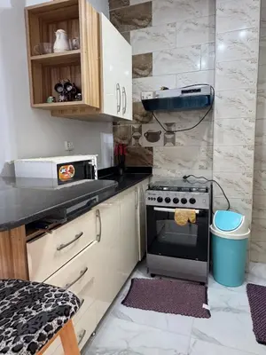 a kitchen with a stove and a counter top at Inter Prime apartment 4 in Hurghada