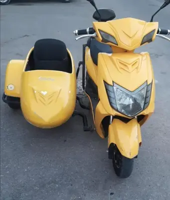 a yellow scooter parked in a parking lot at Mangroovy - 2Br Commodious Pool&Gouna views Condo in Hurghada