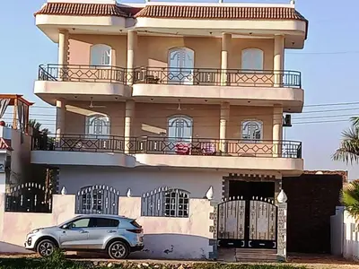 a car parked in front of a large building at family villa private pool in Luxor