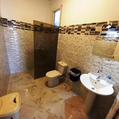 a bathroom with a toilet and a sink at family villa private pool in Luxor