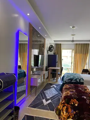 a bedroom with a bed with a purple lighting at فلورينزا الخمسين in Hurghada