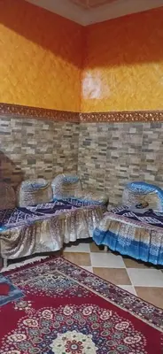 a room with three sets of beds on the wall at Lavande Nubian House in Aswan