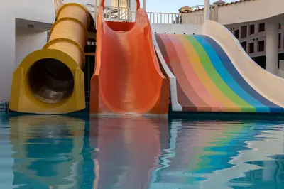 a colorful water slide in a swimming pool at Dexon Roma All Inclusive Hotel in Hurghada
