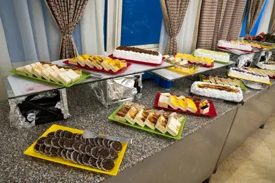 a buffet line with different types of cakes and desserts at Dexon Roma All Inclusive Hotel in Hurghada