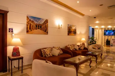 a living room with two couches and two tables at Dexon Roma All Inclusive Hotel in Hurghada