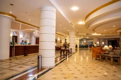 a lobby of a hotel with columns at Dexon Roma All Inclusive Hotel in Hurghada