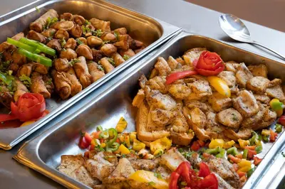 three metal trays filled with different types of food at Dexon Roma All Inclusive Hotel in Hurghada