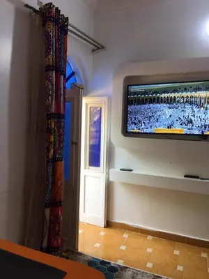 a room with a flat screen tv on a wall at Gana kato in Aswan