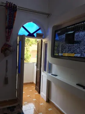 a room with a flat screen tv on a wall at Gana kato in Aswan