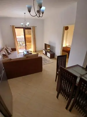 a living room with a couch and a table at 2 bedroom in turtels beach in Hurghada