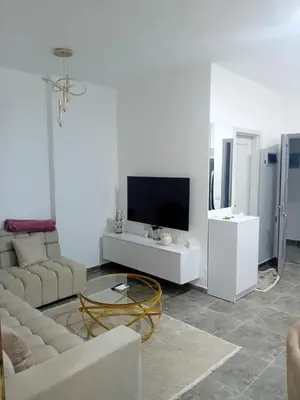 a living room with a couch and a tv at Aqua Infinity D306 in Hurghada
