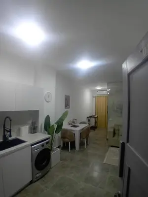 a kitchen with a sink and a table in a room at Aqua Infinity D306 in Hurghada