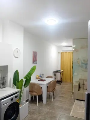a kitchen and living room with a table and chairs at Aqua Infinity D306 in Hurghada