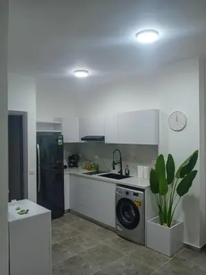 a kitchen with a washing machine and a sink at Aqua Infinity D306 in Hurghada