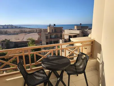 a table and chairs on a balcony with a view at Royal Beach Resort in Hurghada