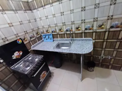 a kitchen with a counter and a sink and a stove at SAMA HOUSE Cozy Mountain Hideaway in Luxor in ‘Ezbet Abu Ḥabashi