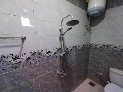 a shower in a bathroom with a toilet at SAMA HOUSE Cozy Mountain Hideaway in Luxor in ‘Ezbet Abu Ḥabashi