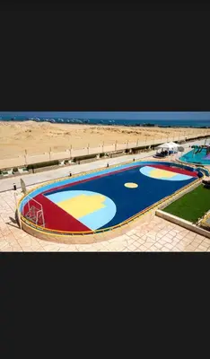 an overhead view of a swimming pool on a beach at Timeshare for rent at sunny days family resort in Hurghada