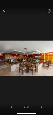 a room with tables and benches in a building at Timeshare for rent at sunny days family resort in Hurghada