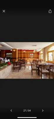 a dining room with tables and chairs in a building at Timeshare for rent at sunny days family resort in Hurghada