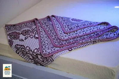 a blanket is sitting on top of a shelf at Heissa Nubian Hostel in Aswân Reservoir Colony
