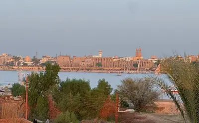 a view of a river with a city in the background at Morsy Palace in Luxor