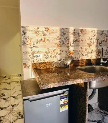 a kitchen with a counter top and a sink at Morsy Palace in Luxor