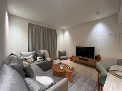 a living room with a couch and a tv at Stylish 1BR Retreat – Ancient Sands El Gouna in Hurghada