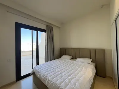 a bedroom with a bed and a large window at Stylish 1BR Retreat – Ancient Sands El Gouna in Hurghada