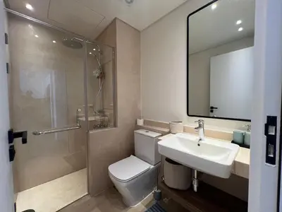 a bathroom with a toilet and a sink and a shower at Stylish 1BR Retreat – Ancient Sands El Gouna in Hurghada