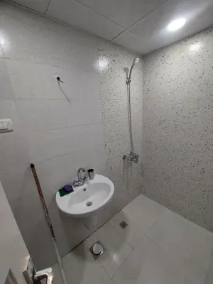 a bathroom with a sink and a shower at Ashria gest house in Jazīrat Salūjah