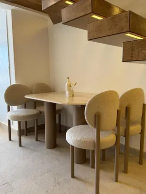 a dining room with a wooden table and chairs at ELGOUNA Maraya duplex pool view in Hurghada