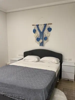 a bedroom with a large bed with blue and white sheets at ELGOUNA Maraya duplex pool view in Hurghada