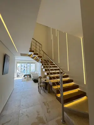 a staircase in a house with a living room at ELGOUNA Maraya duplex pool view in Hurghada