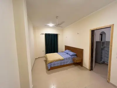 a small bedroom with a bed and a mirror at Cozy Apartment, on Sheraton Road Near Metro Market in Hurghada