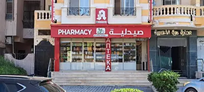 a store with a red sign in front of a building at Florenza Resort - Roboost - Hurghada in Hurghada