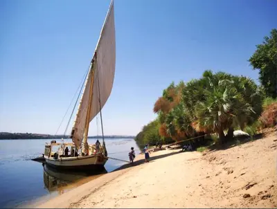 a sail boat on a beach with people on it at Katadool Boat in Aswan
