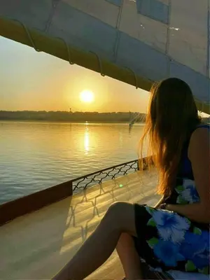 a woman sitting on a boat looking at the water at Katadool Boat in Aswan