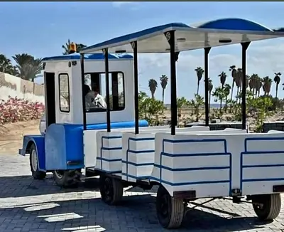 a blue and white golf cart parked on a street at Luxury Studio Pool & Free Private Beach, Close to Airport in Hurghada