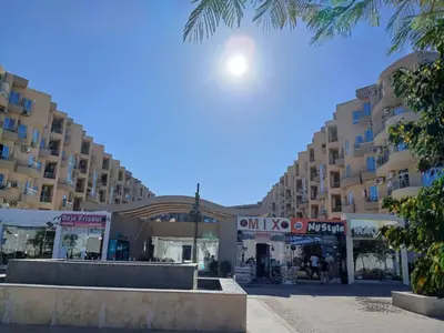 a street in front of a large apartment building at Princess resort in Hurghada